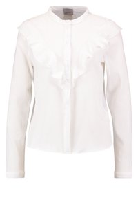 Chemise blanche à manches longues avec col, dotée d'un devant à volants et d'une fermeture à boutons. Le tissu a une apparence texturée.