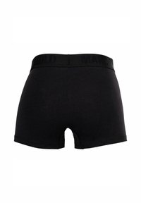Schwarze Baumwoll-Boxershorts mit einem engen Design, ausgestattet mit einem breiten, elastischen Bund, auf dem "MARCO" eingeprägt ist. Glatte Textur und keine sichtbaren Muster.
