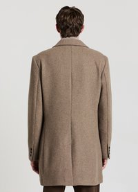 Brauner Wollmantel mit strukturierter Silhouette, notched Revers und einer strukturierten Oberfläche. Mit geknöpften Manschetten und einem minimalistischen Design.