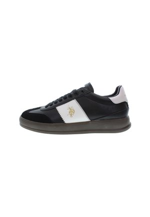 Black sneaker with white and black leather panels, suede accents, round toe, flat sole, and logo detail on the side.