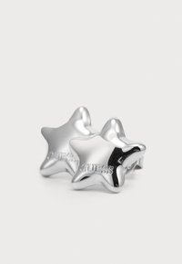 Silver star-shaped earrings with a polished finish, featuring the "GUESS" logo embossed on one side. Smooth texture with a modern design.