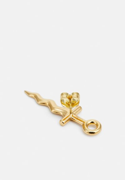 Goldener Haarnadel mit wavy Design und einem runden Akzent oben. Sie verfügt über eine kreisförmige Schlaufe am Ende, die eine polierte Oberfläche hervorhebt.