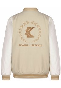 Beige bomberjakke med hvite skinnermuffer, ribbestrikkede mansjetter og hem, med en brodert logo og laurbærdesign på baksiden.