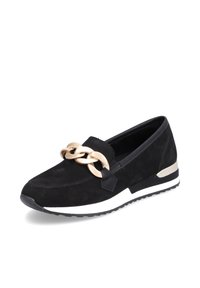 Chaussure slip-on noire avec une semelle blanche épaisse, détail chaîne dorée sur le dessus et petit talon avec accent doré à l'arrière.
