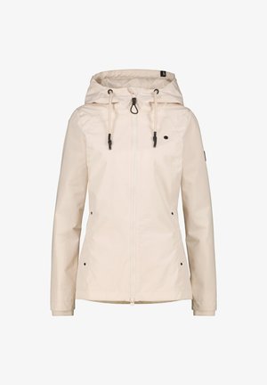 Lichte beige waterdichte jas met capuchon, trekkoorden, rits aan de voorkant en zwarte accenten. Heeft elastische manchetten en twee zijzakken.