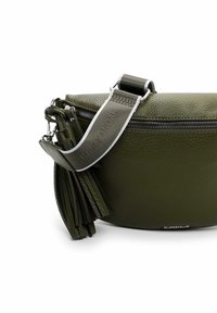 Olive green leather crossbody bag with a textured finish, featuring a prominent zipper and a detachable tassel accent. Adjustable strap included.