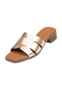 Sandalía metálica dorada con tiras texturizadas, punta abierta y un tacón bajo cuadrado. Plantilla marrón que contrasta con el diseño superior.