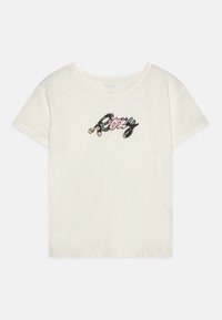 T-shirt en coton à manches courtes de couleur crème avec le mot "Roxy" dans un design multicolore, comportant des éléments floraux et en cursive sur la poitrine.