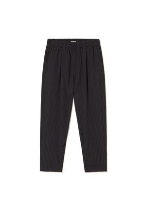 Black pleated pants with an elastic waistband, featuring a textured vertical stripe pattern and tapered legs. Soft fabric, casual design.