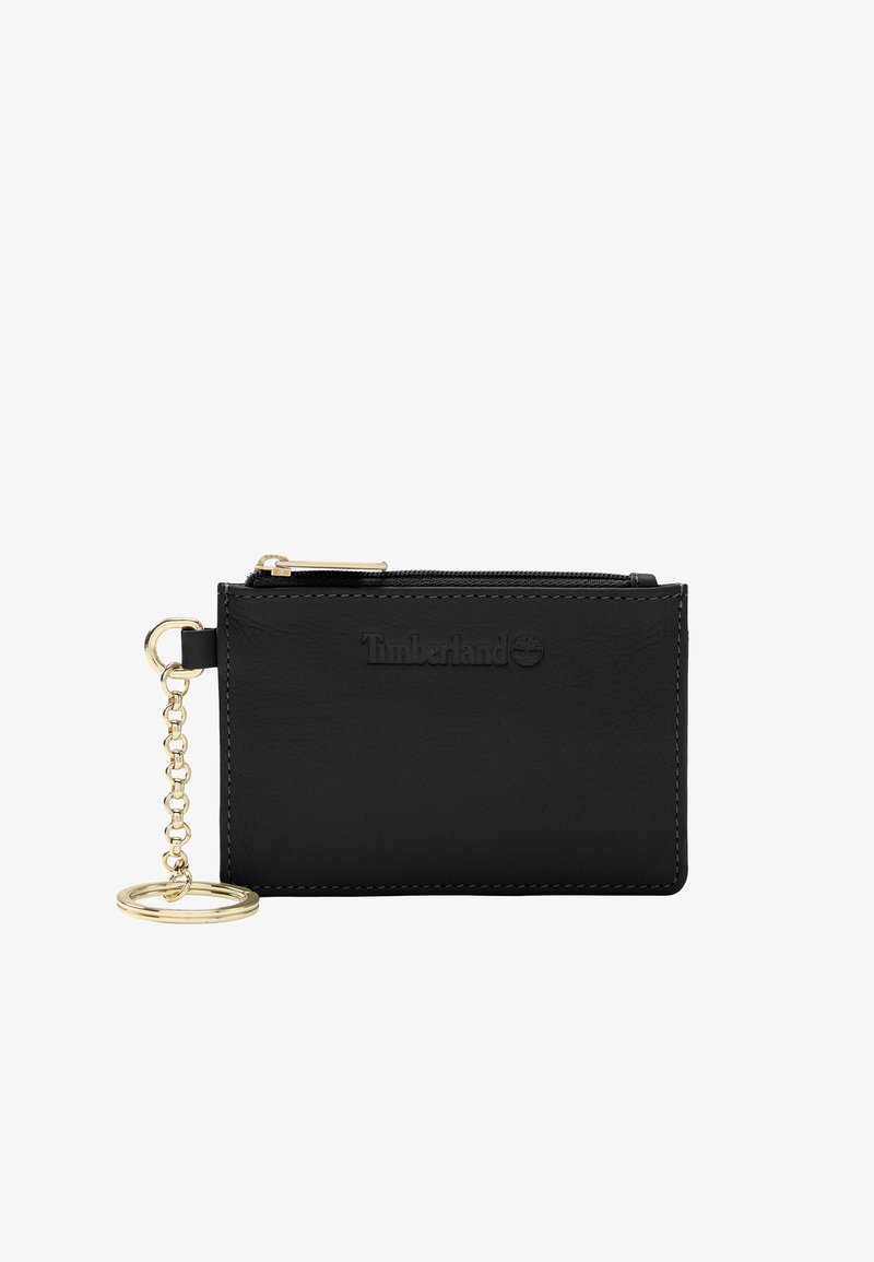 Portefeuille en cuir noir avec une chaîne en or et un porte-clés. Il présente une fermeture éclair et le logo Timberland embossé sur le devant.