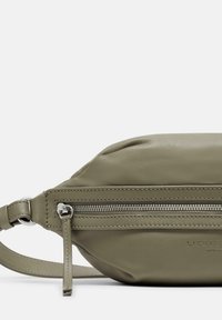 Sac en cuir vert olive avec une texture lisse, doté d'une fermeture éclair argentée et de détails de couture. Comprend une bandoulière pour le porter.
