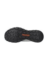 Black rubber outsole with deep tread pattern for grip. Features "SKECHERS STEADY GRIP" branding in orange on the sole.