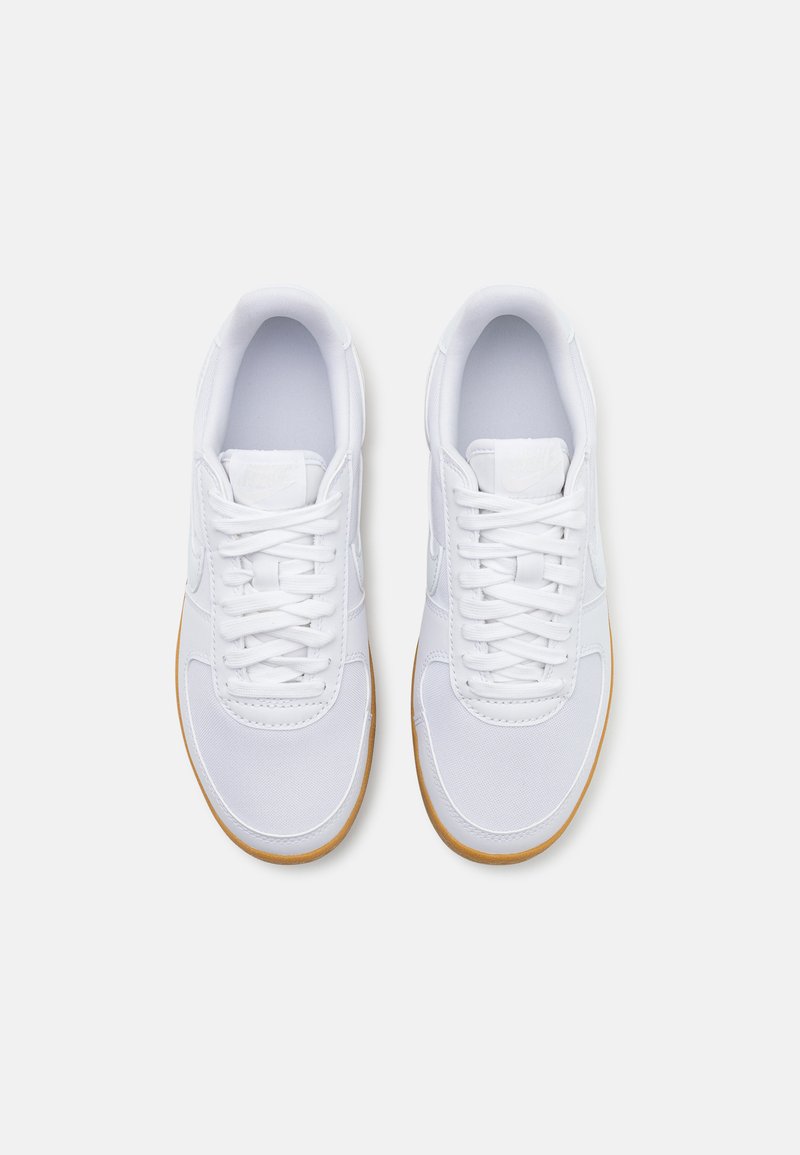 Sneakers bianche con tomaia in tessuto e sintetico, lacci piatti, collo imbottito, soletta circolare in gomma con accenti in gomma, superficie liscia, punta arrotondata.