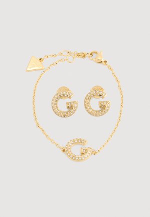 Gold-tone jewelry set featuring G-shaped earrings and a bracelet, embellished with clear rhinestones and a clasp closure.
