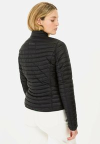 Black quilted jacket with a high neck, featuring horizontal stitching and a fitted design. Smooth texture and minimal hardware visible.