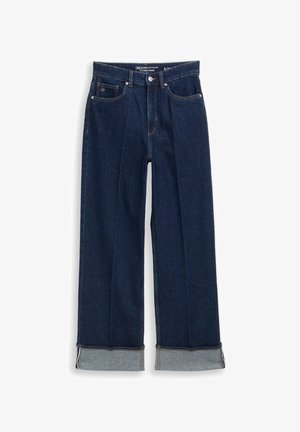 Wijde denim jeans in donkerblauw met lichtblauwe omgeslagen zomen, voorzien van oranje stiksels en voorzakken. Gemaakt van stevig denimstof.