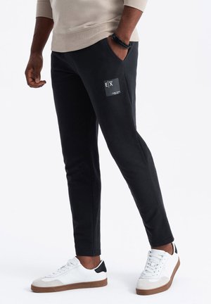 OM-PASK - Tracksuit bottoms - black