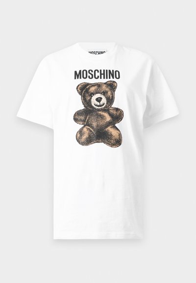 White cotton t-shirt featuring a bear graphic in brown and black, with "MOSCHINO" printed above in bold black lettering.