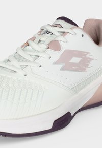 White and light pink sports shoe with laces, textured toe area, logo on side, and purple-tinted sole visible on a plain background.