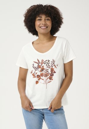 T-shirt en coton blanc avec un col en V, arborant un motif floral marron au centre. Le t-shirt a des manches courtes et une coupe décontractée.