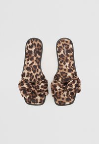 Sandály s leopardím vzorem na slip-on s velkou mašlí vpředu. Měkký materiál, čtveratý tvar špičky a černá gumová podrážka.
