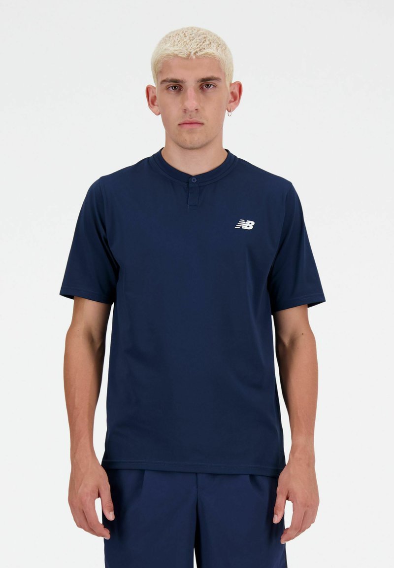 Navy blue short-sleeve shirt with a henley collar, featuring a subtle logo on the left chest. Smooth texture, athletic fit.