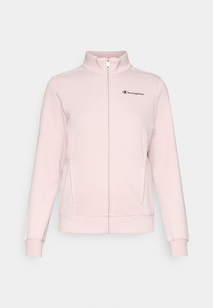 Kerge roosa lukuga jakker kõrge kaelusega, pikkade varrukatega, taskutega ja musta logoga vasakul rinnal. Pehme kangas sujuva tekstuuriga.