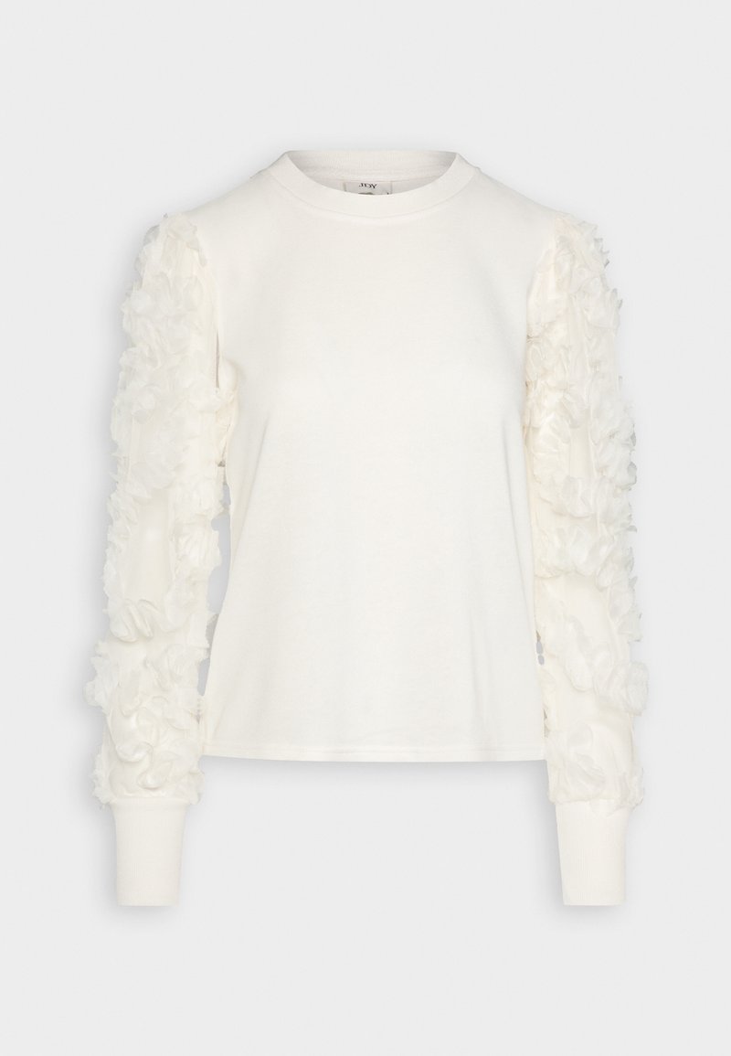 Haut blanc manches longues avec encolure ronde et ornements floraux transparents et texturés sur les deux manches.