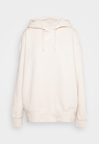 Ljusbeige hoodie i mjukt tyg, med stor huva, dragsnören och en liten vit logotyp på bröstet. Lös passform.