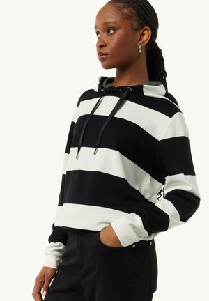 Striped hoodie in black and white, with a drawstring hood, long sleeves, and a soft texture. Features side pockets and a relaxed fit.