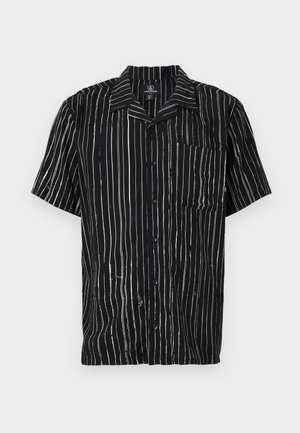 Short-sleeve shirt in black fabric featuring vertical white stripes, a pocket on the left chest, and a collar with a relaxed fit.