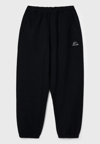 Schwarze Jogginghosen mit elastischem Bund, zwei Seitentaschen und engen Bündchen. Mit einem kleinen weißen Logo auf der linken Seite.