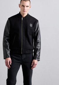 EYTYS CYRUS RAVEN - Flared Jeans - black