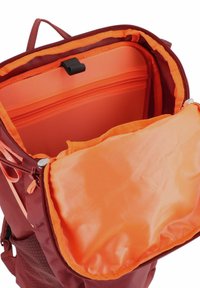 Rode rugzak interior met een heldere oranje voering, voorzien van een ritszak en een zachte, gevoerde compartiment zonder versieringen.