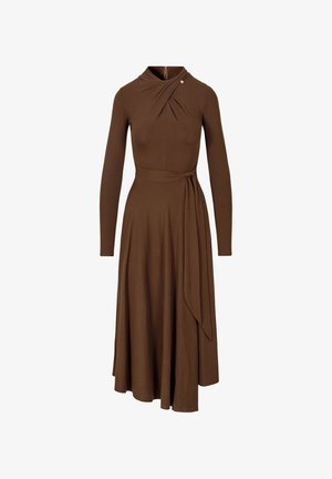 Bruine midi-jurk met lange mouwen, hoge hals, asymmetrische plooien, zijrits en een tailleband die aan één kant naar beneden drapeert.