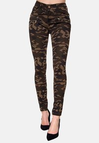 Tarnleggings in Grüntönen und Brauntönen mit Reißverschlusstaschen, enganliegendem Schnitt und glatter Textur.