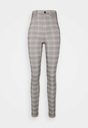 Pantalon taille haute ajusté avec un motif à carreaux noir, blanc et gris et une fermeture à boutons à l'avant.