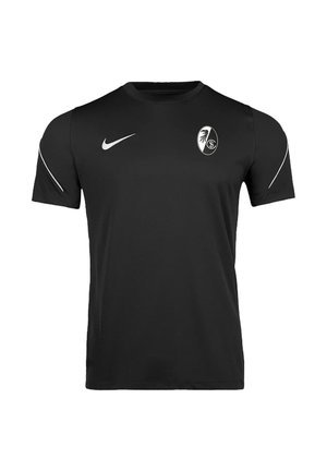 Sort kortærmet sportstrøje med Nike-logo på højre bryst og hvid cirkulær emblema med ørn på venstre bryst.