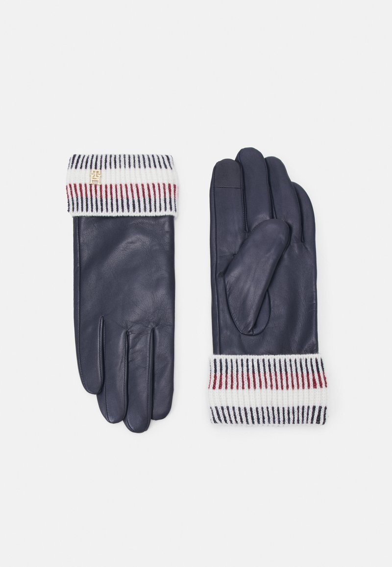 Marineblauwe leren handschoenen met een geribde gebreide manchet in witte, rode en marineblauwe strepen. Voorzien van een klein logo-accent op de manchet.