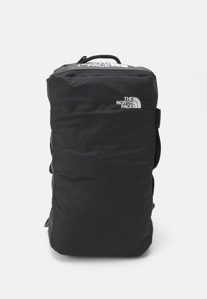 Black backpack made of durable material, featuring a top handle, adjustable strap, and a logo on the front. Rectangular shape with zip closure.