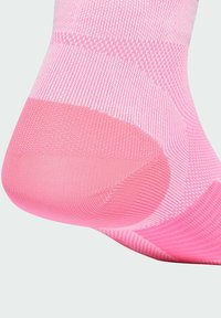 Pink athletic sock featuring a textured design with varying shades, breathable mesh, and a reinforced heel for durability.