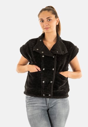 Zwarte, korte mouwen jas van pluche stof met een grote kraag, drukknoopsluiting en twee voorkeepockets. Het materiaal heeft een zachte, gestructureerde uitstraling.