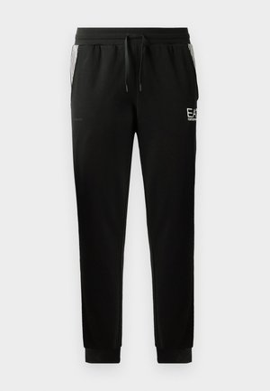 Black sweatpants with a drawstring waist, tapered legs, ribbed cuffs, and graphic logo detail on the front and striped accents on the sides.
