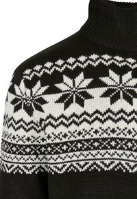 Suéter negro de punto con cuello alto; presenta patrones de copos de nieve y geométricos en todo. Textura suave, diseño casual.
