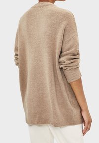 Beige knitted sweater with a relaxed fit, long sleeves, ribbed cuffs, and texture. Back view shows a soft, warm fabric.