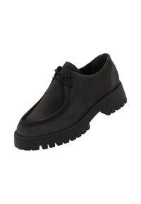 Black suede lace-up shoe with a rounded toe, contrasting stitching, and a chunky rubber sole featuring pronounced treads.