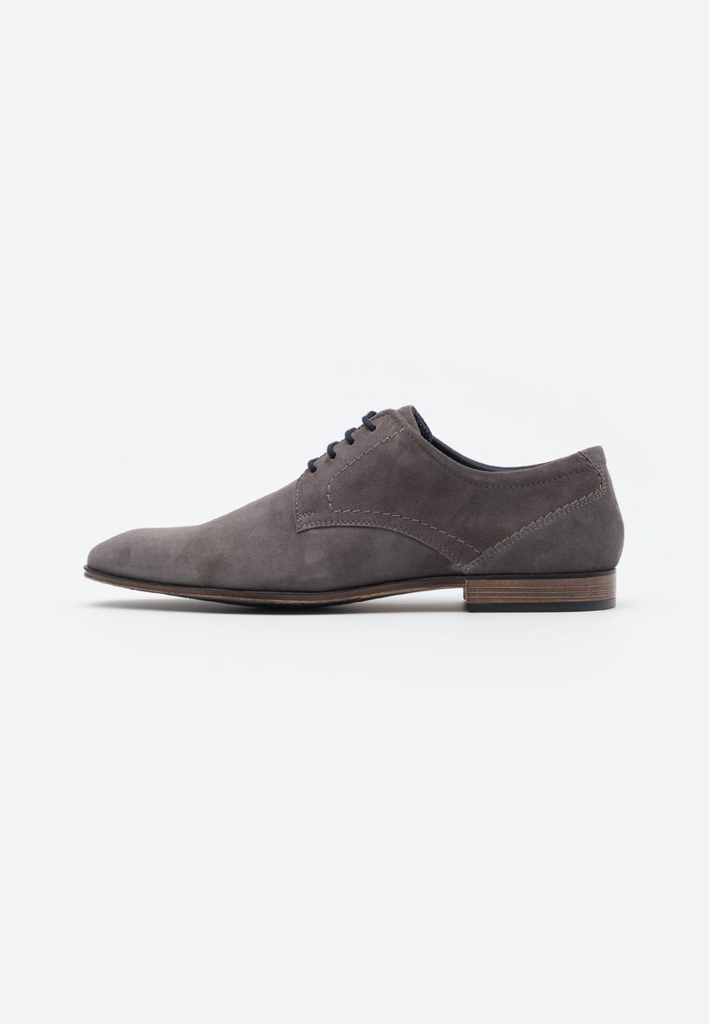Gray suede oxford shoe with a pointed toe, stitched detailing, and wooden heel, showcasing a classic, minimalist design.