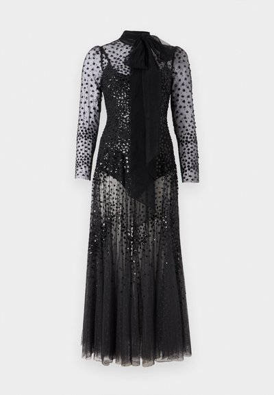 Must have käesleeved must võrkmaterjalist õhtukleit, millel on sädeleva polka täppidega, poolläbipaistev seeliku pealispind, vormitud body ja suur seotud kaelasall.