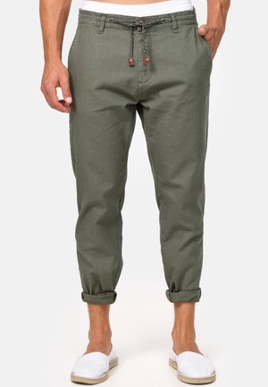 Olive green linen pants with a drawstring waist, rolled cuffs, and two side pockets. Features contrasting brown accents on drawstring tips.