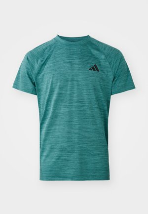 Teal athletic t-shirt with a textured, moisture-wicking fabric. Features short sleeves and a black logo on the left chest area.
